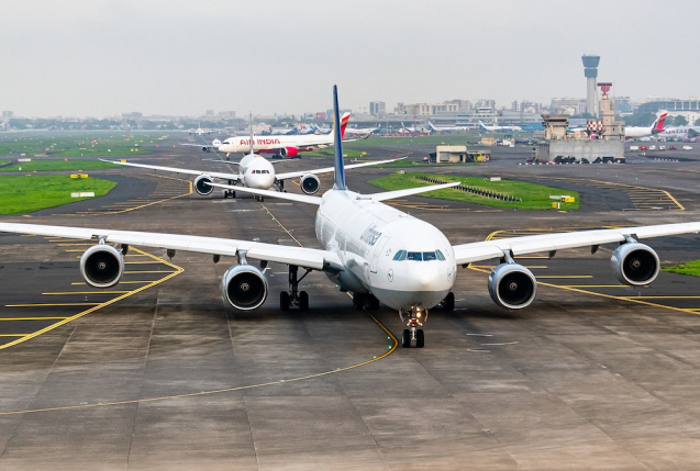 Airbus A340-600 von Lufthansa rollt zur Startbahn, im Hintergrund Flugzeuge von Air India., © AirTeamImages.com/Anshul Kadam