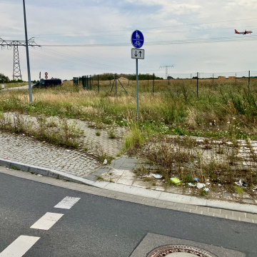 Straße am Flughafen BER mit Flugzeug am Himmel., © Thomas Rietig