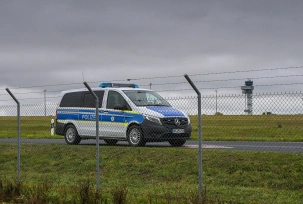 Ein Polizeifahrzeug steht auf dem Gelände des Flughafens Leipzig/Halle., © DPA/Heiko Rebsch